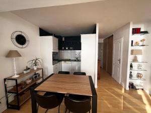 a kitchen and dining room with a table and chairs at Studio spacieux face mer avec balcon et garage, proche plage et commerces aux Sables-d'Olonne - FR-1-197-561 in Les Sables-dʼOlonne