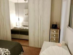 a bedroom with a mirror and a bed and a dresser at HOME ADRIANA in Bari