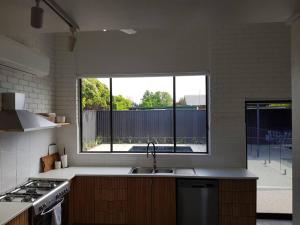 a kitchen with a sink and a large window at Perfect Large Multi Family Accommodation in Yarrawonga