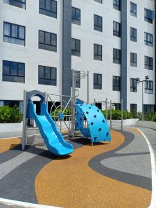 a playground in front of a building with a slide at The Horizon by Mykey Global in Ipoh