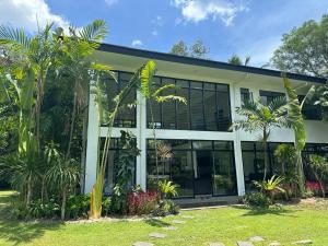 un edificio con palmeras delante en G-HOTEL LUXURY VILLA RESORT AND HOT SPRING en Calamba