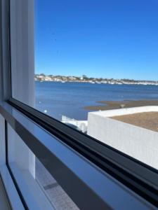 a window with a view of the ocean at Ocean view 2 Bedroom apartment in Sydney