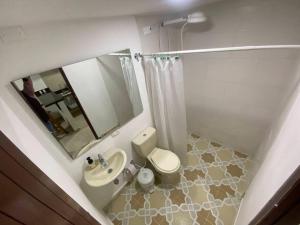 a bathroom with a sink and a toilet and a mirror at Apto - 1802B - Vista Única in Bogotá