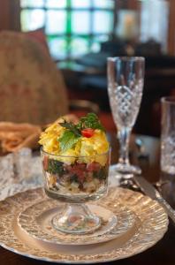 a dish of food on a plate on a table at Victorian House Bed and Breakfast in Saint Augustine