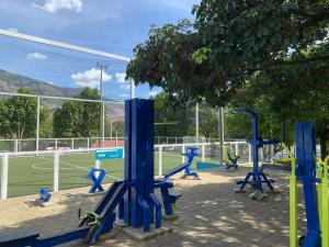 a tennis court with blue equipment on a tennis court at Acogedor Apartamento Urbanización Tricentenario in Medellín