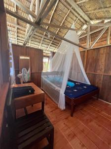 um quarto com uma cama com uma rede em Junior Homestay em Kri