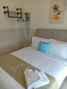 a white bed with two towels on top of it at The Horizon by Mykey Global in Ipoh