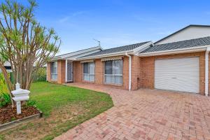 a brick house with a garage on a brick driveway at 3 Redman Place in Soldiers Point