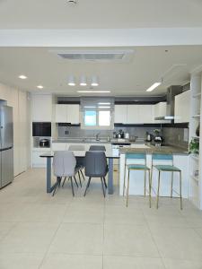a large kitchen with a table and chairs in it at Eastern View Premium Residence in Ulsan