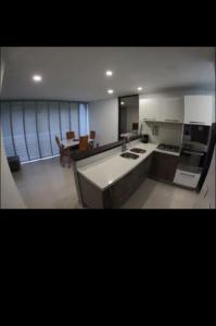 a kitchen with a sink and a stove top oven at Hermoso y tranquilo apartasuite in Floridablanca
