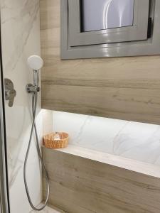 a shower in a bathroom with a sink at BlueLine apartment 2 in Loutraki