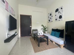 a living room with a couch and a table at Home Tales 1 - by Tipiverse in Bangalore