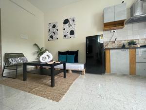 a living room with a table and a kitchen at Home Tales 1 - by Tipiverse in Bangalore
