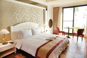 Letto o letti in una camera di Kenting Moli Bay Seaview Resort Hotel