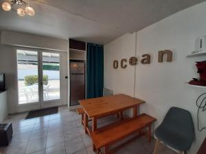 a dining room with a wooden table and a chair at Villa Patio Charmante, 2 Pas des Plages, Terrasse, Parking, Piste Cyclable - FR-1-239-892 in Capbreton +21 photos