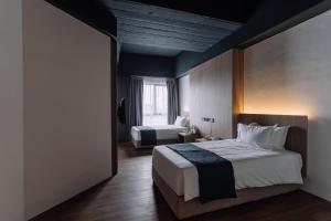 Postel nebo postele na pokoji v ubytování Impiana by Roxy Hotel
