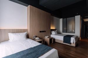 Postel nebo postele na pokoji v ubytování Impiana by Roxy Hotel