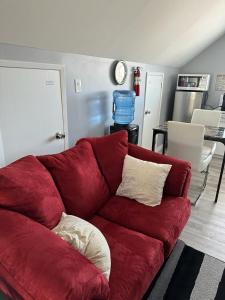a red couch sitting in a living room at Spotless 2 Bedrooms Suite 2 in Winnipeg in Winnipeg