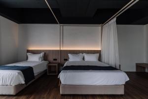 Postel nebo postele na pokoji v ubytování Impiana by Roxy Hotel