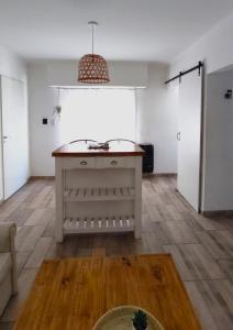 a living room with a island in the middle of a room at SoHo Flat in Tandil