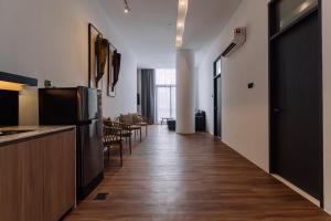 a hallway with a kitchen and a living room at Impiana by Roxy Hotel in Kuching