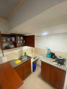 a kitchen with a sink and a counter top at Apartaestudio privado con aire cerca Aeropuerto in Cali