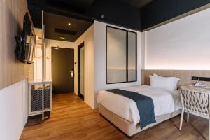 Postel nebo postele na pokoji v ubytování Impiana by Roxy Hotel