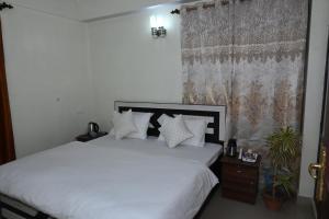Postel nebo postele na pokoji v ubytování Om Niwas Homestay