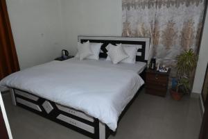 Postel nebo postele na pokoji v ubytování Om Niwas Homestay