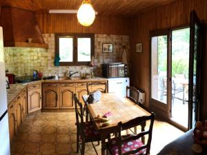 a kitchen with a table and some chairs in a room at Chalet Bernex, 5 pièces, 10 personnes - FR-1-498-94 in Bernex