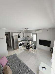 a living room with a bed and a kitchen at BlueLine apartment 3 in Loutraki