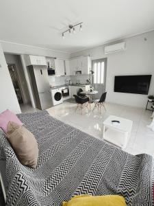 a bedroom with a bed and a living room at BlueLine apartment 3 in Loutraki