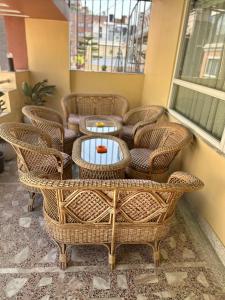 a group of wicker chairs and a table in a room at Grand Yak Boutique Hotel in Kathmandu