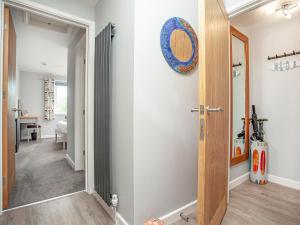 a hallway with a door leading to a bedroom at 6 Camelside in Wadebridge