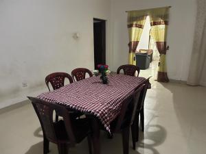 a table with chairs and a red and white checkered table cloth at Shalomi's villa & Happy Home in Negombo +21 photos