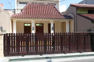 a wooden fence in front of a house at Griya Hanna in Yogyakarta