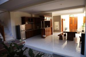 a kitchen with a refrigerator and a table at Griya Hanna in Yogyakarta