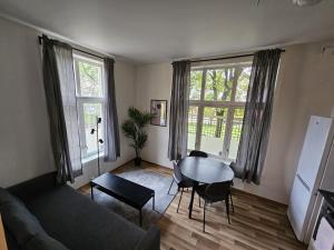 a living room with a couch and a table at Grünerløkka shared Apartment Rooms in Oslo