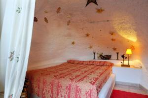 a bedroom with a bed with stars on the wall at Castillo Lanzarote Villa 1 - Sleep in a Volcanic Cave in Tías