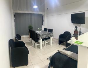 a living room with a dining room table and chairs at EL DEPTO tipo dúplex pleno centro incluye cochera Consultar Servicio de parking in Monte Grande