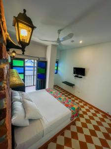 a bedroom with a bed with a checkered floor at The Orange House Santa Marta in Santa Marta