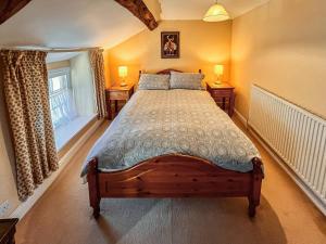 a bedroom with a large bed with two lamps on tables at Church Street in Ambleside