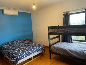 a bedroom with two bunk beds and a window at Bairnsdale Workers Accommodation in Lucknow