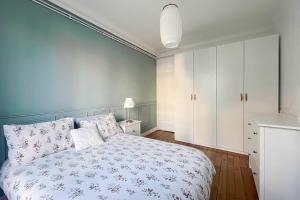 a bedroom with a bed and a white cabinet at Renewed and well-decorated apartment in Paris 12th in Paris