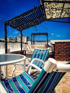 two chairs and a table on a patio at The Orange House Santa Marta in Santa Marta