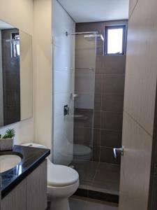 a bathroom with a shower and a toilet and a sink at Panorama central in Bogotá