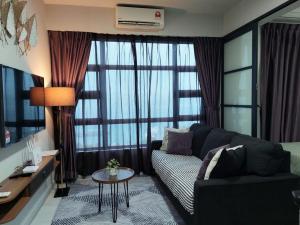 a living room with a couch and a large window at J'Stay Seaview Suite Jesselton Quay Kota Kinabalu in Kota Kinabalu