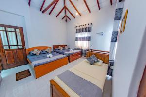 a room with two beds in a room at Ciel Grand Villa in Kandy