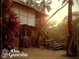 a house with a staircase leading to a porch at Om Ganesha in Palolem