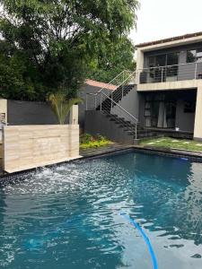 una piscina frente a una casa en Moraswi Apartment on 31 Forest Road, en Johannesburgo